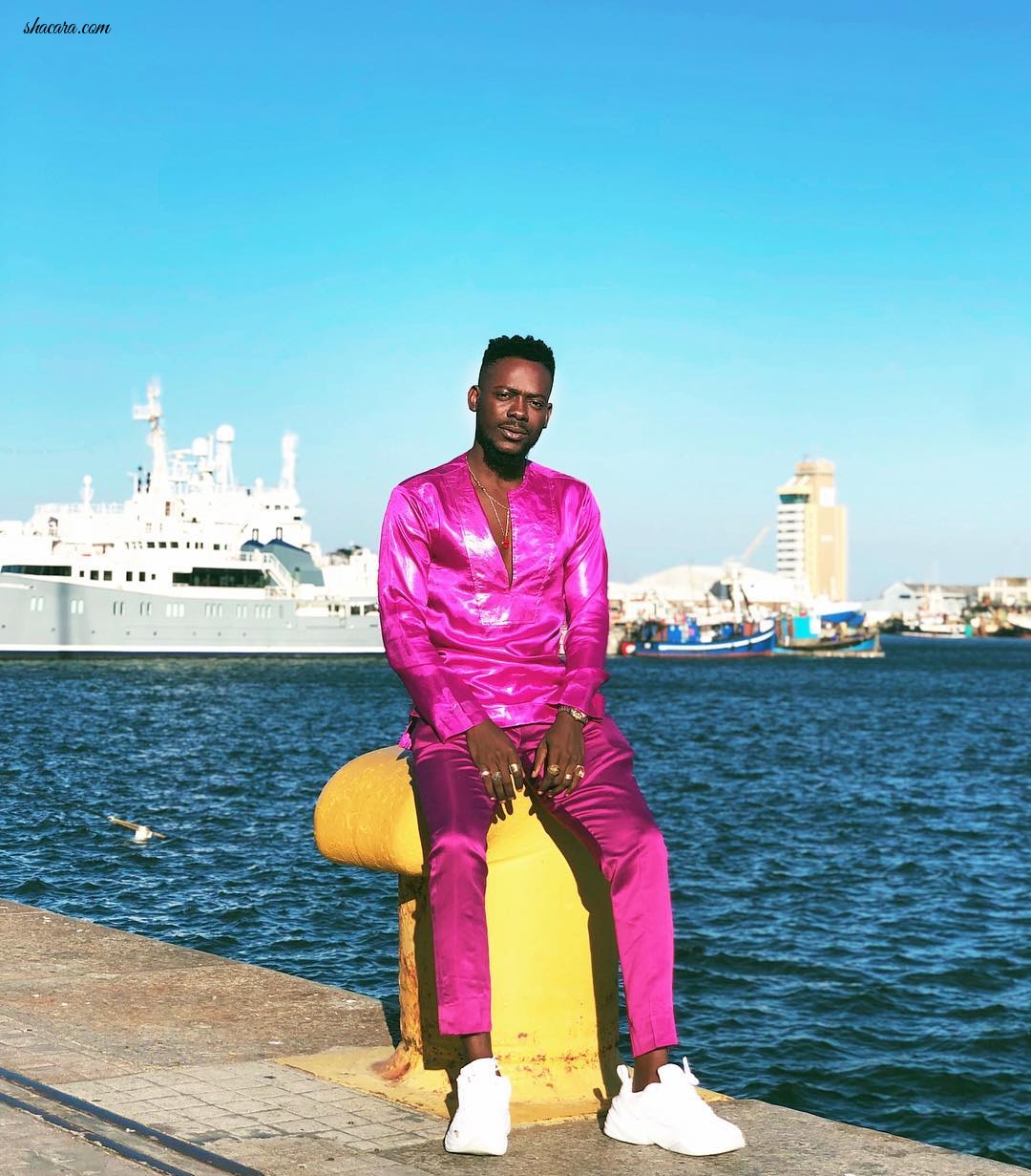 Of Course Adekunle Gold Wears Fuchsia Silk Set When He’s On Vacation